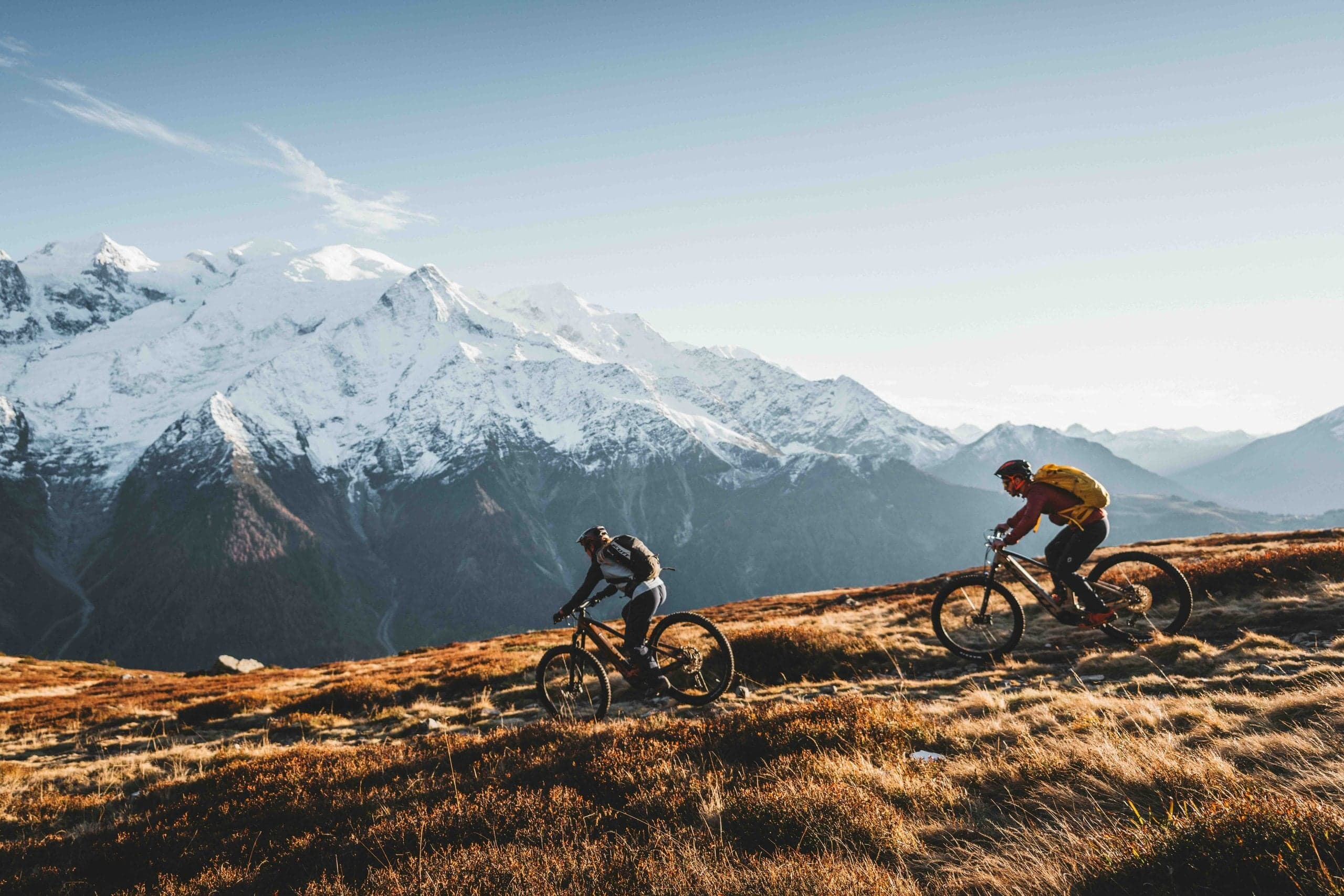 Early morning e-bike ride through Chamonix valley with golden light on the mountains